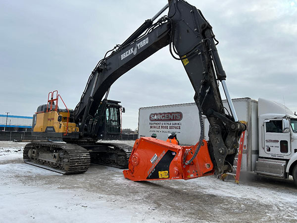 mobile service truck working on an excavator in the snow