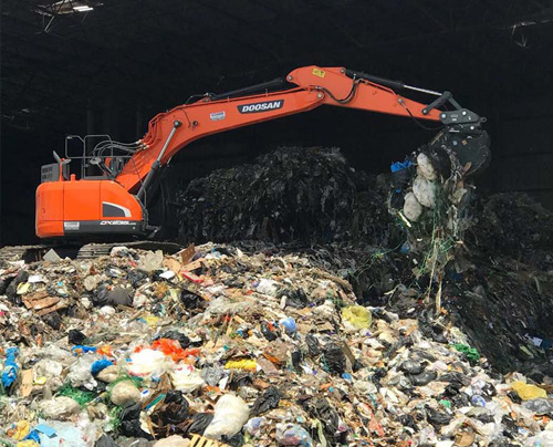 doosan excavator in a landfill